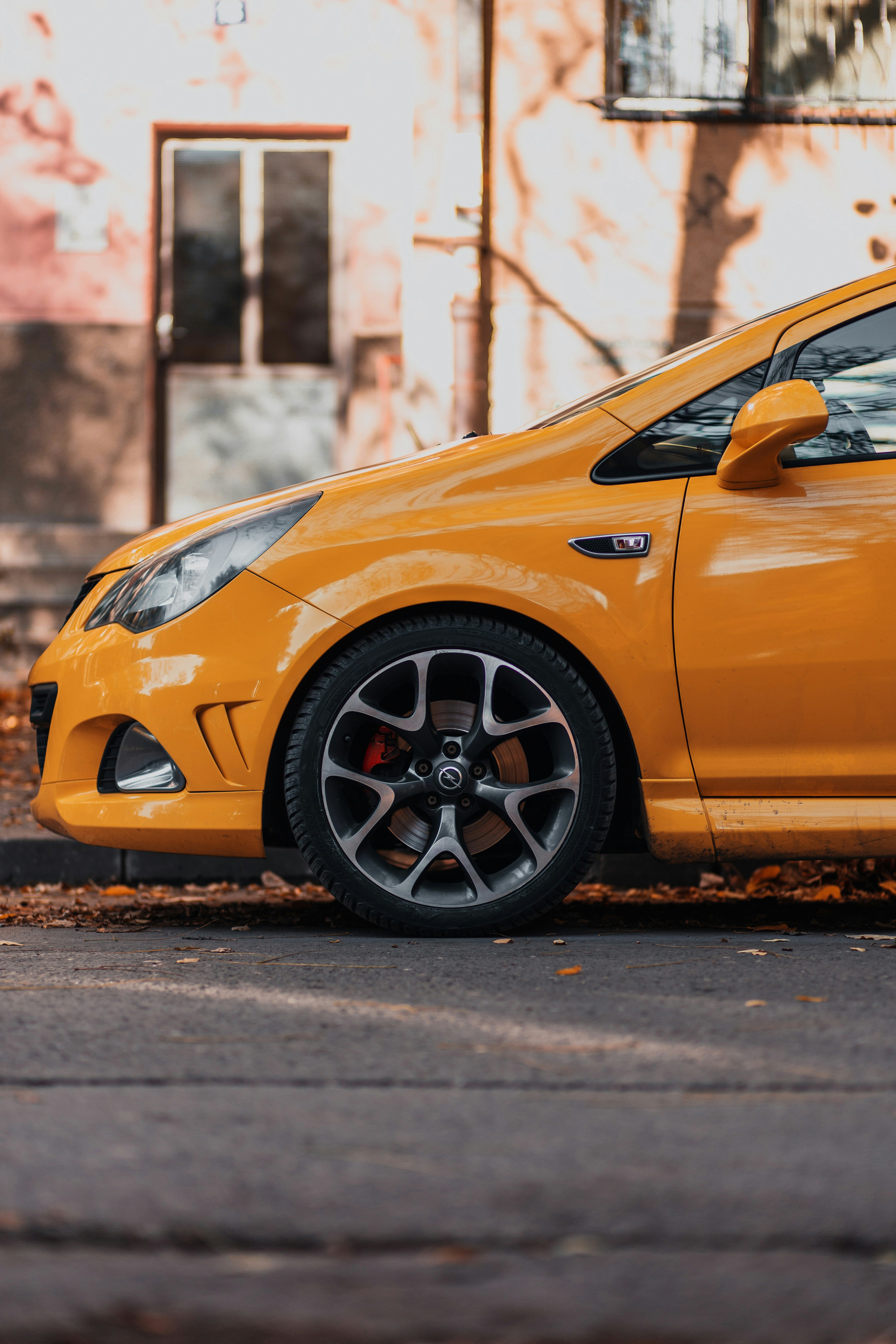 yellow car on black asphalt road during daytime